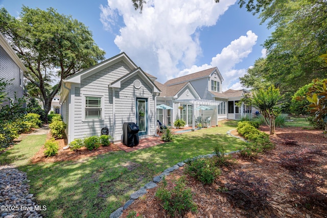 8508 Hammock Dunes Dr, Wilmington, NC 28411 - back of house featuring a pergola, a patio area, and a yard