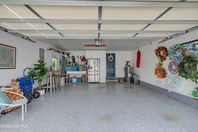 8508 Hammock Dunes Dr, Wilmington, NC 28411 - garage with stainless steel fridge with ice dispenser, a garage door opener, and electric water heater