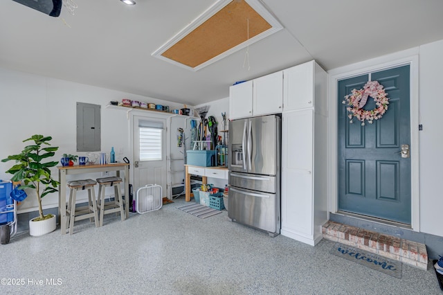 8508 Hammock Dunes Dr, Wilmington, NC 28411 - garage featuring stainless steel fridge with ice dispenser and electric panel