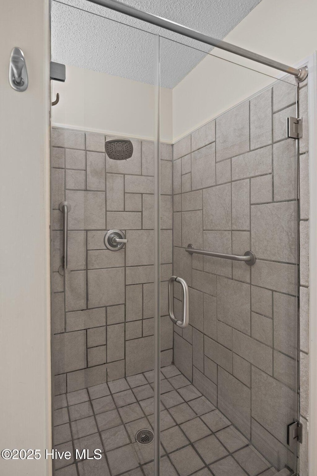 2639 Plumosa Dr, Grimesland, NC 27837 - bathroom with a shower stall and a textured ceiling