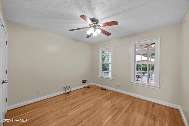 2639 Plumosa Dr, Grimesland, NC 27837 - spare room featuring light wood-style flooring, a textured ceiling, and a ceiling fan