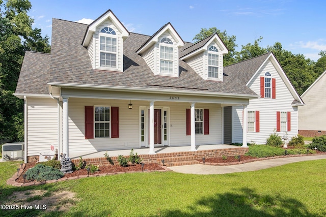 2639 Plumosa Dr, Grimesland, NC 27837 - cape cod house with a front lawn, a shingled roof, and covered porch