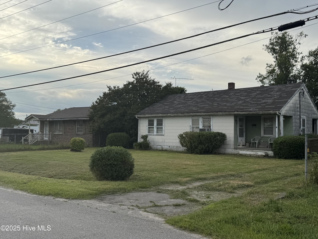 2013 Noland Rd E, Wilson, NC 27893 - view of front of property featuring a front yard, a chimney, and covered porch