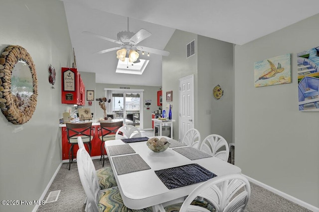 1785 New River Inlet Rd Unit 2, North Topsail Beach, NC 28460 - dining area with light colored carpet, ceiling fan, high vaulted ceiling, and a skylight