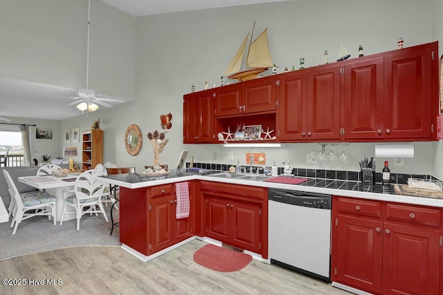 1785 New River Inlet Rd Unit 2, North Topsail Beach, NC 28460 - kitchen with dishwasher, light wood-style flooring, a ceiling fan, a peninsula, and a high ceiling
