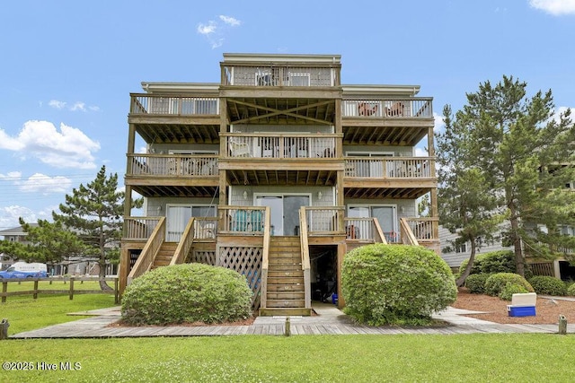1785 New River Inlet Rd Unit 2, North Topsail Beach, NC 28460 - coastal home with a balcony, stairs, and a front yard