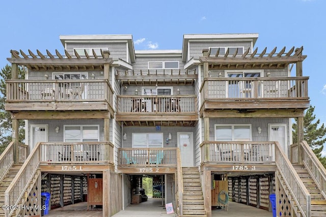 1785 New River Inlet Rd Unit 2, North Topsail Beach, NC 28460 - back of property with stairway, a balcony, and covered porch