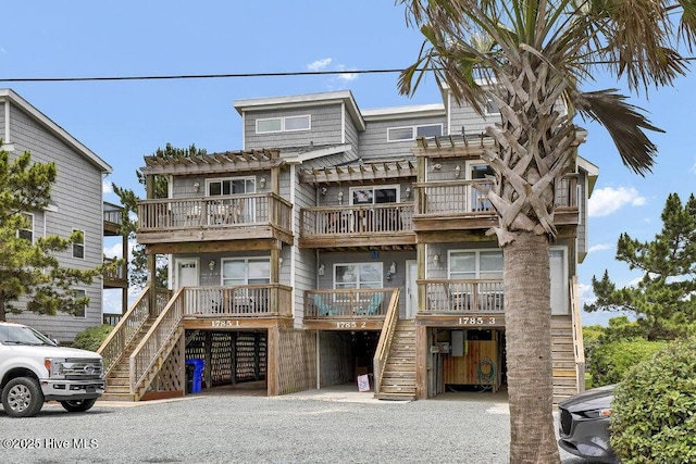 1785 New River Inlet Rd Unit 2, North Topsail Beach, NC 28460 - view of front facade with stairs, a pergola, and a balcony