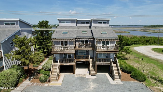 1785 New River Inlet Rd Unit 2, North Topsail Beach, NC 28460 - view of front of house featuring stairs, a shingled roof, an attached garage, driveway, and a deck with water view