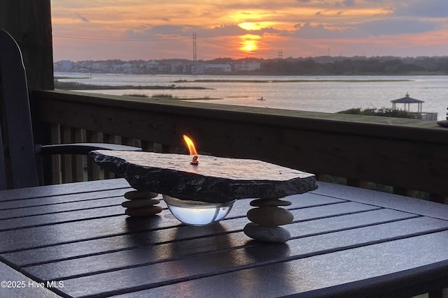1785 New River Inlet Rd Unit 2, North Topsail Beach, NC 28460 - patio terrace at dusk featuring an outdoor fire pit and a water view