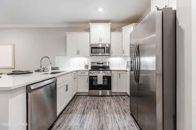 395 S Crow Creek Dr Unit 1712, Calabash, NC 28467 - kitchen featuring appliances with stainless steel finishes, a peninsula, light countertops, white cabinets, and decorative backsplash