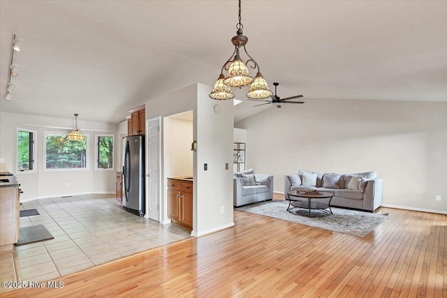 120 Shagbark Ct, Seven Lakes, NC 27376 - living area with vaulted ceiling, light wood-style flooring, ceiling fan, and a chandelier