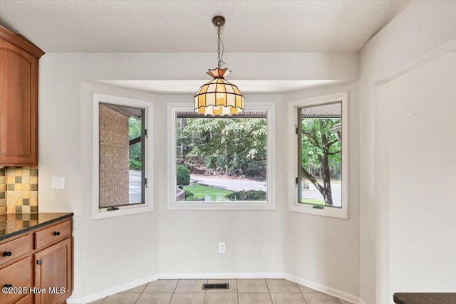 120 Shagbark Ct, Seven Lakes, NC 27376 - unfurnished dining area with light tile patterned flooring and baseboards
