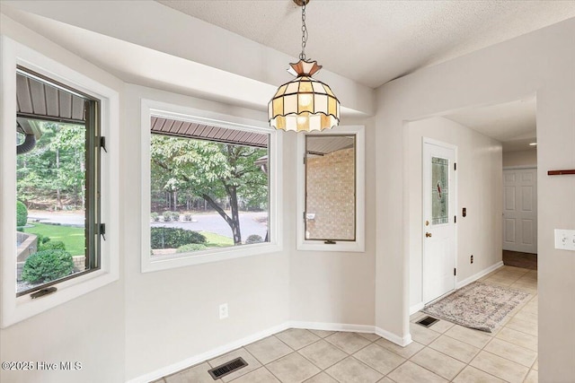 120 Shagbark Ct, Seven Lakes, NC 27376 - unfurnished dining area featuring healthy amount of natural light, light tile patterned floors, and a textured ceiling
