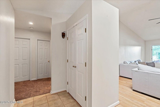120 Shagbark Ct, Seven Lakes, NC 27376 - hallway featuring light carpet, lofted ceiling, recessed lighting, and light tile patterned flooring