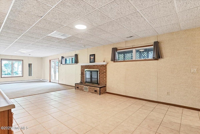 120 Shagbark Ct, Seven Lakes, NC 27376 - unfurnished living room featuring a baseboard heating unit, a paneled ceiling, and a fireplace