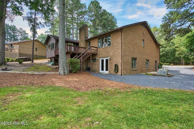 120 Shagbark Ct, Seven Lakes, NC 27376 - back of house with a chimney, a deck, french doors, brick siding, and a lawn