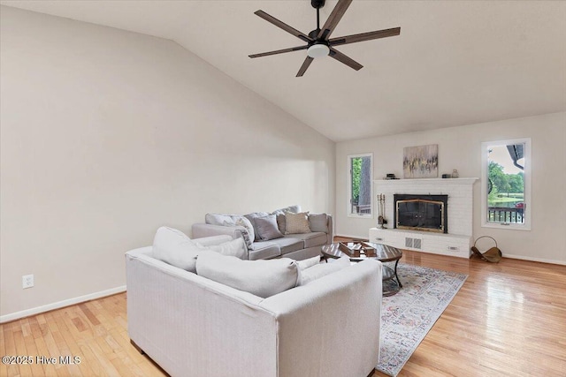 120 Shagbark Ct, Seven Lakes, NC 27376 - living room with a ceiling fan, wood finished floors, a brick fireplace, and high vaulted ceiling