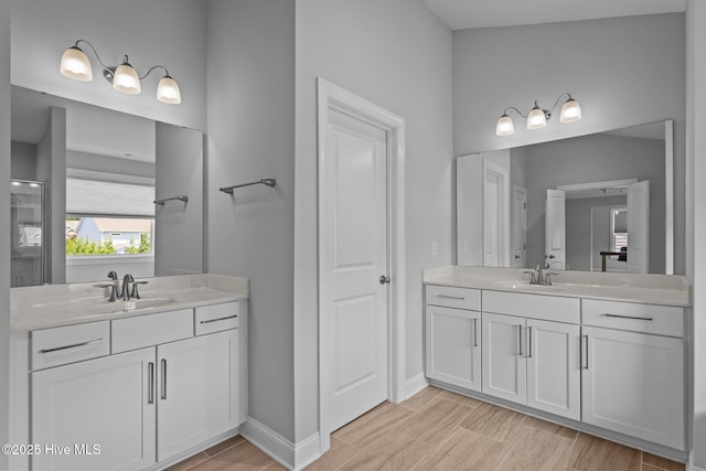 1035 Bent Blade Ln, Wilmington, NC 28411 - full bathroom featuring two vanities and wood finished floors