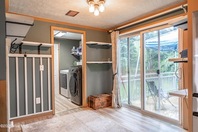 1360 Rays Bridge Rd, Whispering Pines, NC 28327 - laundry room featuring washing machine and dryer, wood finished floors, a textured ceiling, and crown molding