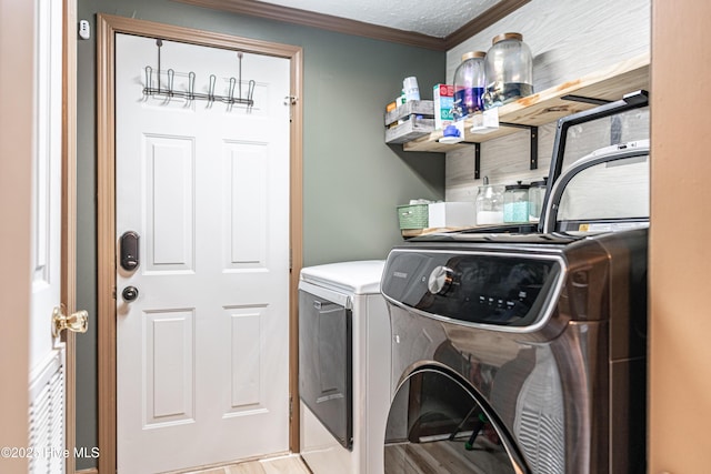 1360 Rays Bridge Rd, Whispering Pines, NC 28327 - washroom featuring washer and clothes dryer, crown molding, and light wood-style floors