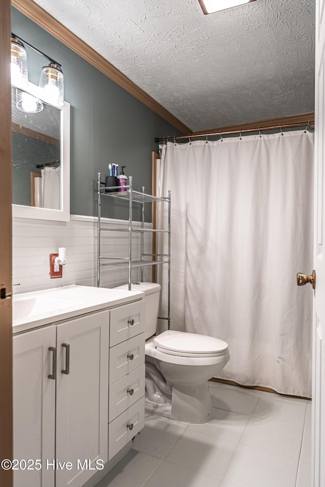 1360 Rays Bridge Rd, Whispering Pines, NC 28327 - bathroom with crown molding, vanity, a textured ceiling, and tile patterned flooring