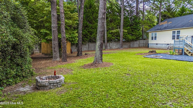 1360 Rays Bridge Rd, Whispering Pines, NC 28327 - fenced backyard featuring an outdoor fire pit