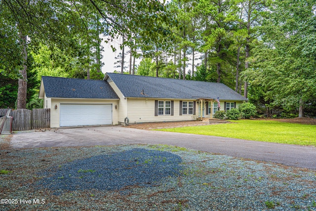 1360 Rays Bridge Rd, Whispering Pines, NC 28327 - single story home with asphalt driveway and an attached garage