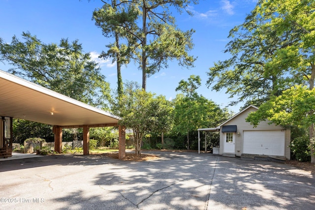 1909 Pawnee Dr, Kinston, NC 28504 - view of patio / terrace with driveway, an outdoor structure, and a detached garage