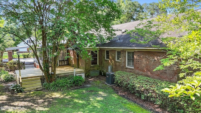 1909 Pawnee Dr, Kinston, NC 28504 - back of house with roof with shingles, a wooden deck, and brick siding