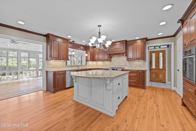 1909 Pawnee Dr, Kinston, NC 28504 - kitchen with appliances with stainless steel finishes, light wood finished floors, crown molding, a chandelier, and a center island