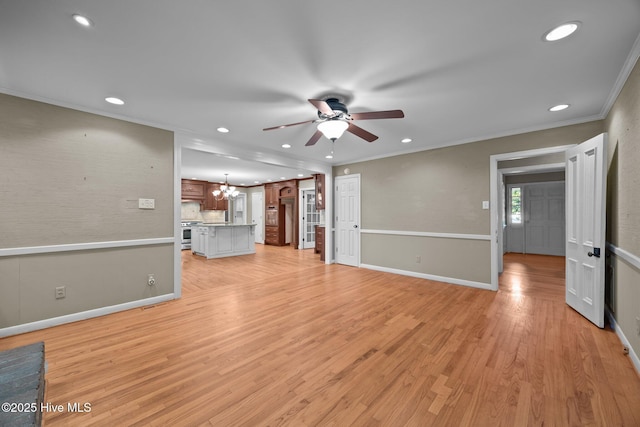 1909 Pawnee Dr, Kinston, NC 28504 - unfurnished living room with a ceiling fan, ornamental molding, recessed lighting, light wood-style flooring, and a chandelier