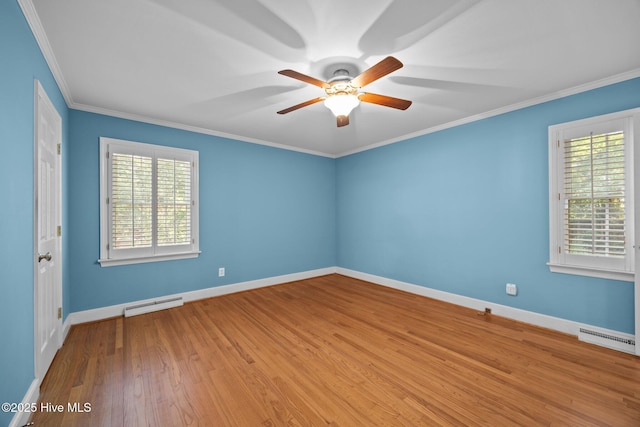 1909 Pawnee Dr, Kinston, NC 28504 - empty room featuring healthy amount of natural light, a ceiling fan, wood finished floors, crown molding, and baseboard heating