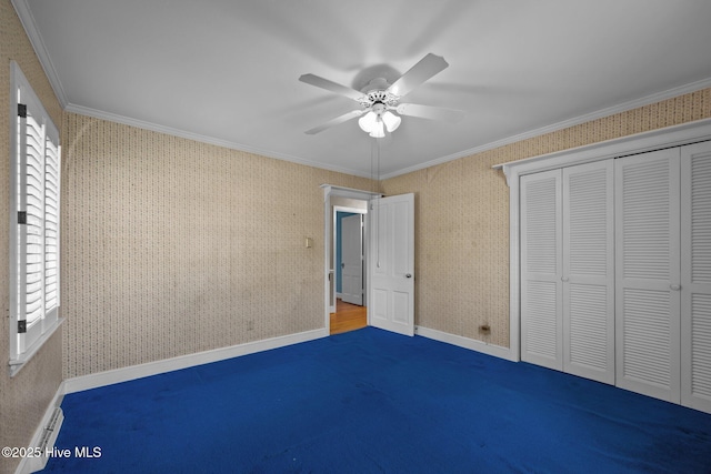 1909 Pawnee Dr, Kinston, NC 28504 - unfurnished bedroom featuring ornamental molding, a closet, ceiling fan, and wallpapered walls