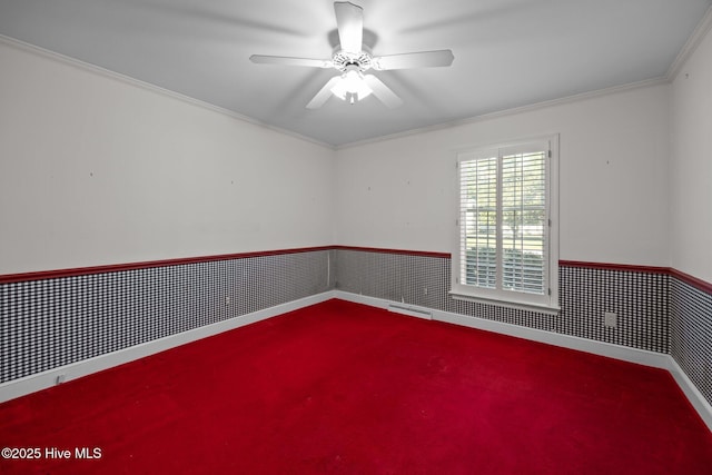 1909 Pawnee Dr, Kinston, NC 28504 - empty room featuring carpet floors, wainscoting, a ceiling fan, and ornamental molding