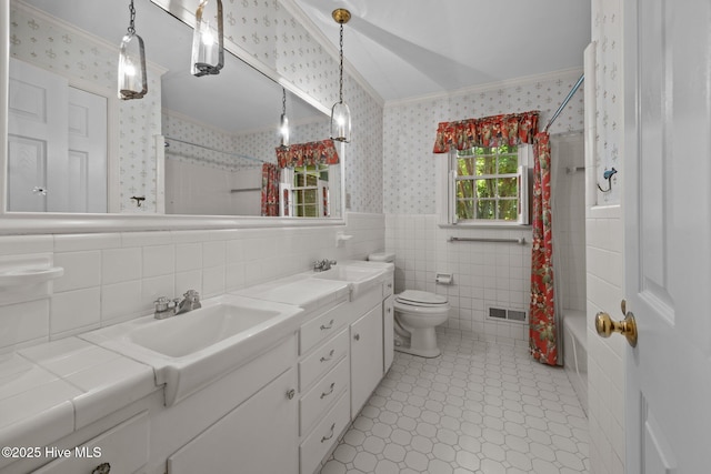 1909 Pawnee Dr, Kinston, NC 28504 - full bathroom featuring crown molding, wallpapered walls, vanity, tile walls, and shower / tub combo with curtain