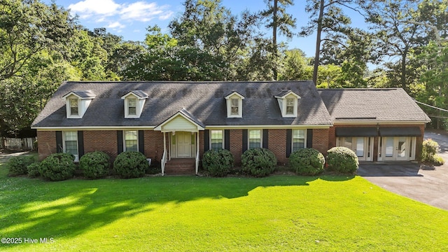 1909 Pawnee Dr, Kinston, NC 28504 - cape cod house featuring brick siding, a front lawn, and driveway