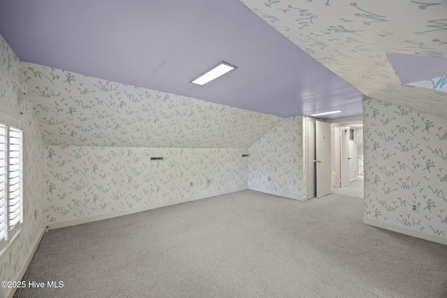 1909 Pawnee Dr, Kinston, NC 28504 - bonus room with wallpapered walls, light carpet, and lofted ceiling
