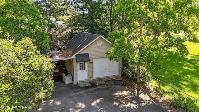 1909 Pawnee Dr, Kinston, NC 28504 - view of outbuilding with a carport, view of scattered trees, driveway, and a garage
