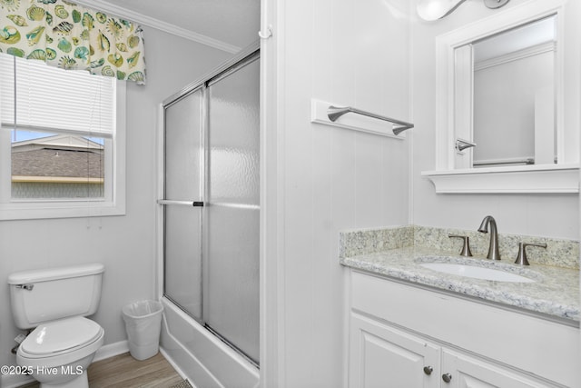 2101 Ocean Dr Unit A, Emerald Isle, NC 28594 - bathroom featuring vanity, crown molding, combined bath / shower with glass door, and wood finished floors
