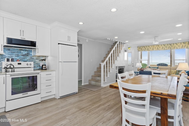 2101 Ocean Dr Unit A, Emerald Isle, NC 28594 - dining area with stairway, light wood-style flooring, recessed lighting, and a textured ceiling