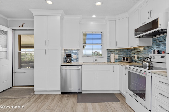 2101 Ocean Dr Unit A, Emerald Isle, NC 28594 - kitchen featuring stainless steel appliances, white cabinetry, decorative backsplash, recessed lighting, and light wood-style floors