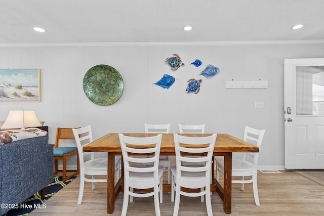 2101 Ocean Dr Unit A, Emerald Isle, NC 28594 - dining room with crown molding, light wood-style flooring, and recessed lighting
