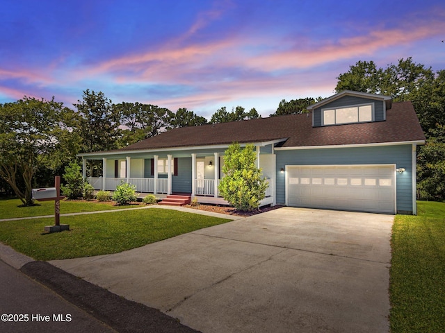 639 W Shore Dr, Swansboro, NC 28584 - view of front facade with covered porch, driveway, a front yard, a garage, and roof with shingles