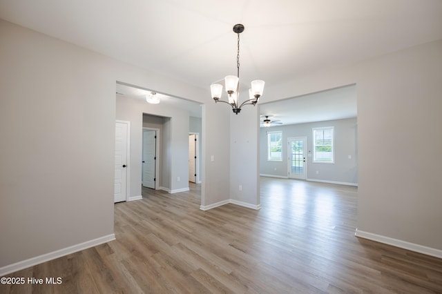 6001 Farmwood Loop, Wilson, NC 27896 - unfurnished room featuring a chandelier, wood finished floors, and a ceiling fan