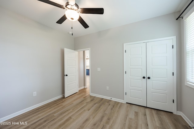 6001 Farmwood Loop, Wilson, NC 27896 - unfurnished bedroom with light wood-style flooring, a closet, and ceiling fan