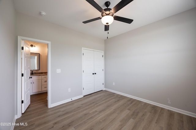 6001 Farmwood Loop, Wilson, NC 27896 - unfurnished bedroom with wood finished floors, a closet, and a ceiling fan