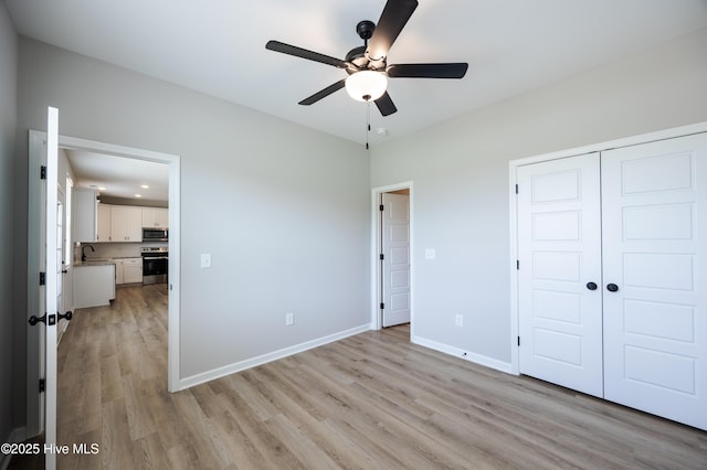 6001 Farmwood Loop, Wilson, NC 27896 - unfurnished bedroom with light wood-type flooring, a closet, and ceiling fan
