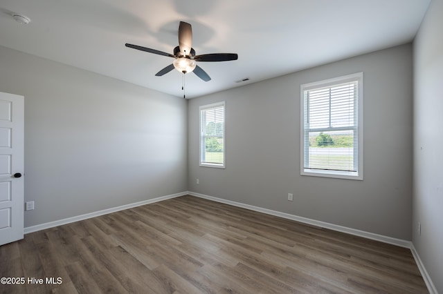 6001 Farmwood Loop, Wilson, NC 27896 - unfurnished room with wood finished floors, a ceiling fan, and a smoke detector