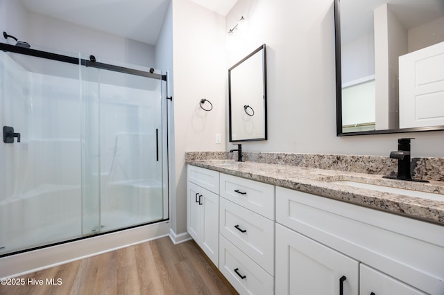 6001 Farmwood Loop, Wilson, NC 27896 - full bath with wood finished floors, double vanity, and a shower stall